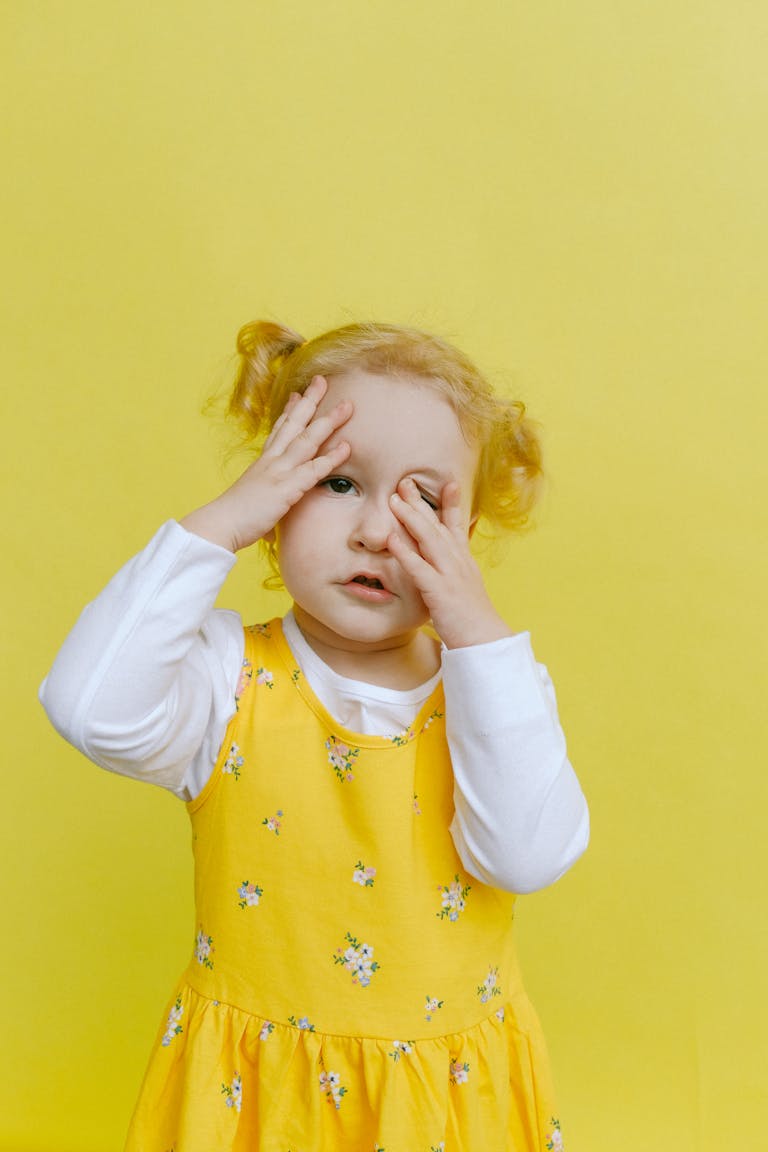 Adorable toddler with hands on face - itchiness due to "wind"